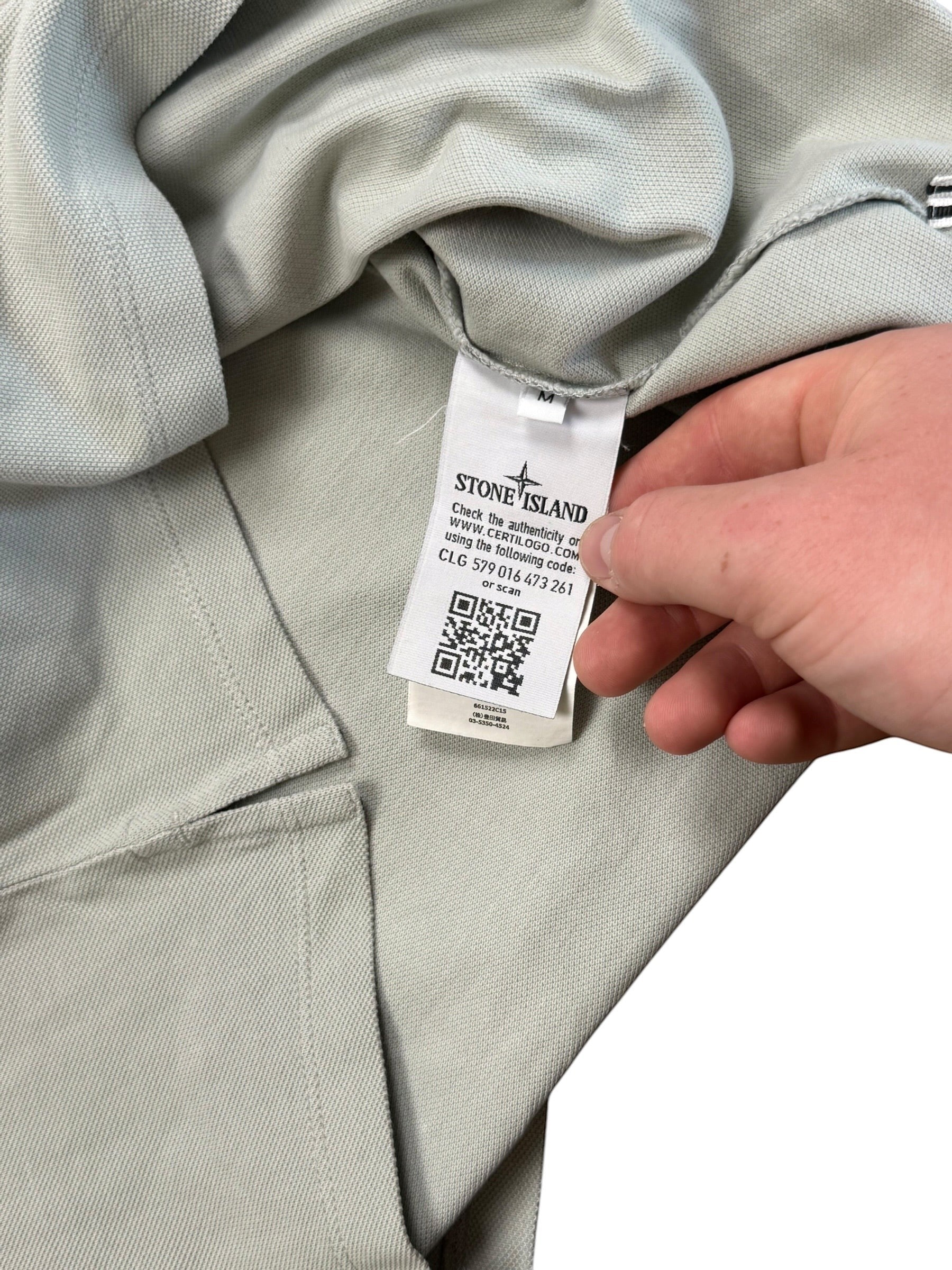 Archive No.9 Stone Island beige cotton polo shirt showing the interior Certilogo authenticity tag and size label.