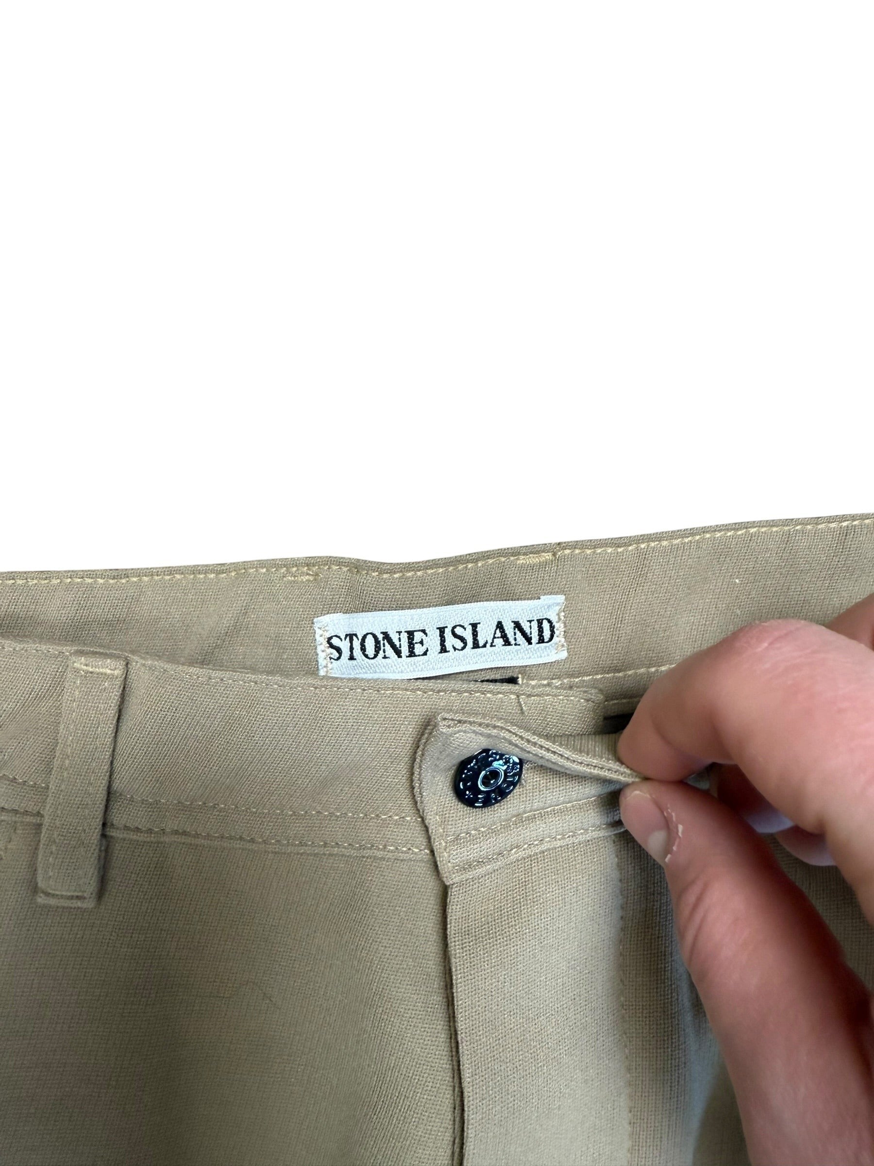 Archive No. 9 Stone Island beige 1996 Marina trousers, size W36, featuring a button closure and leather patch detail.