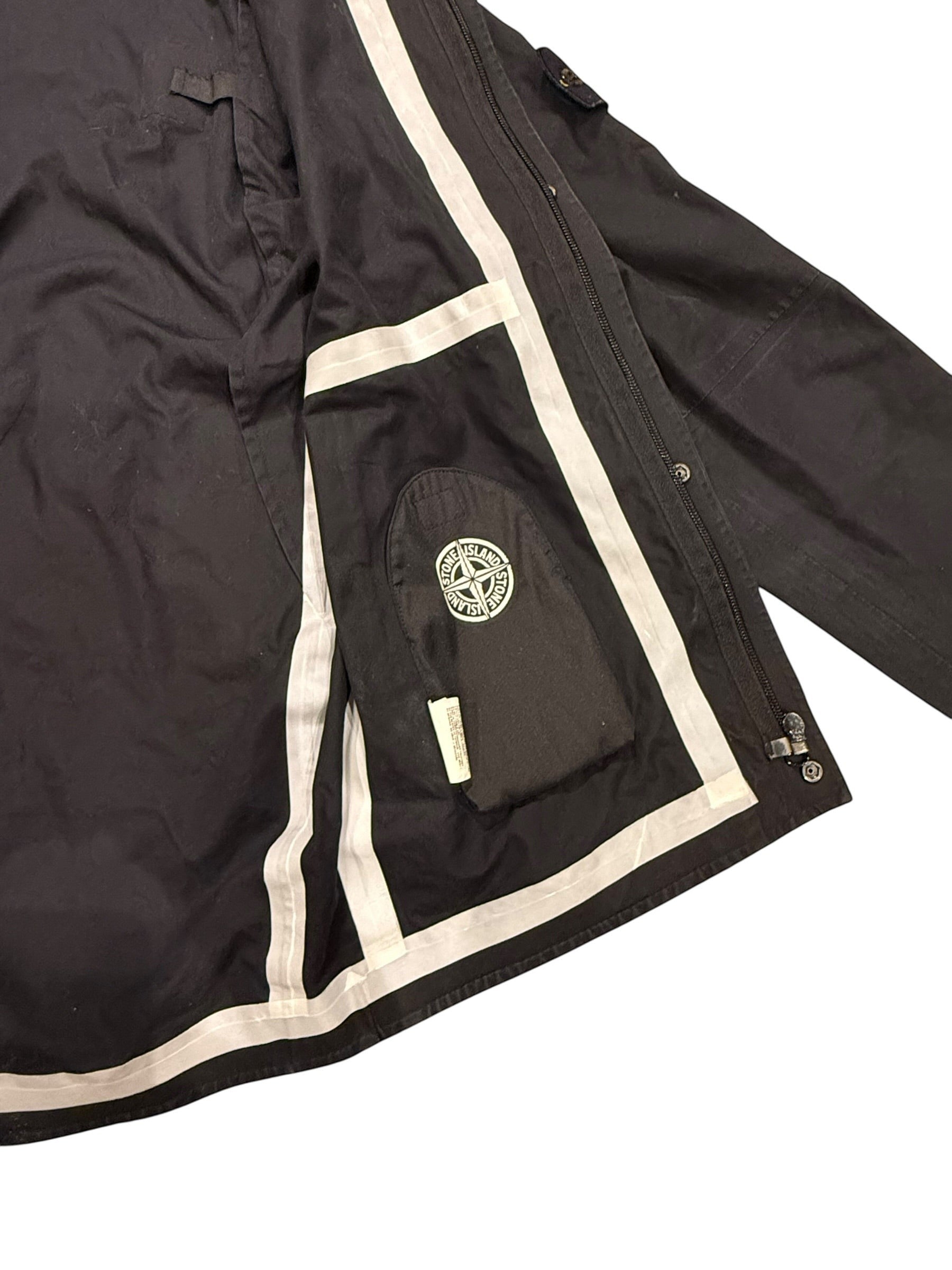 Archive No. 9 black Stone Island Ventile windbreaker jacket with zip-in hood, reflective trim, and internal Stone Island logo patch.