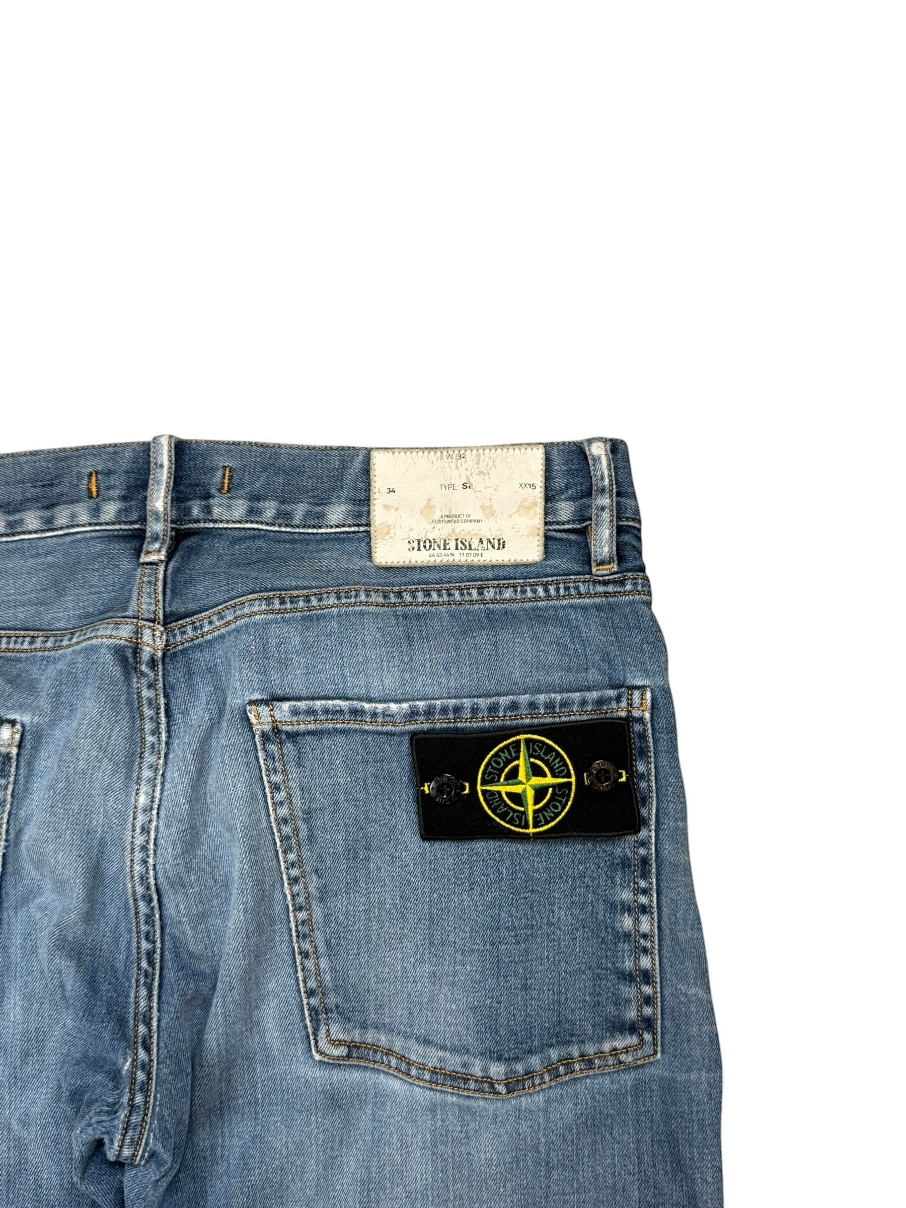 Archive No. 9 vintage blue denim jeans with iconic Stone Island compass badge on back pocket, size W32.