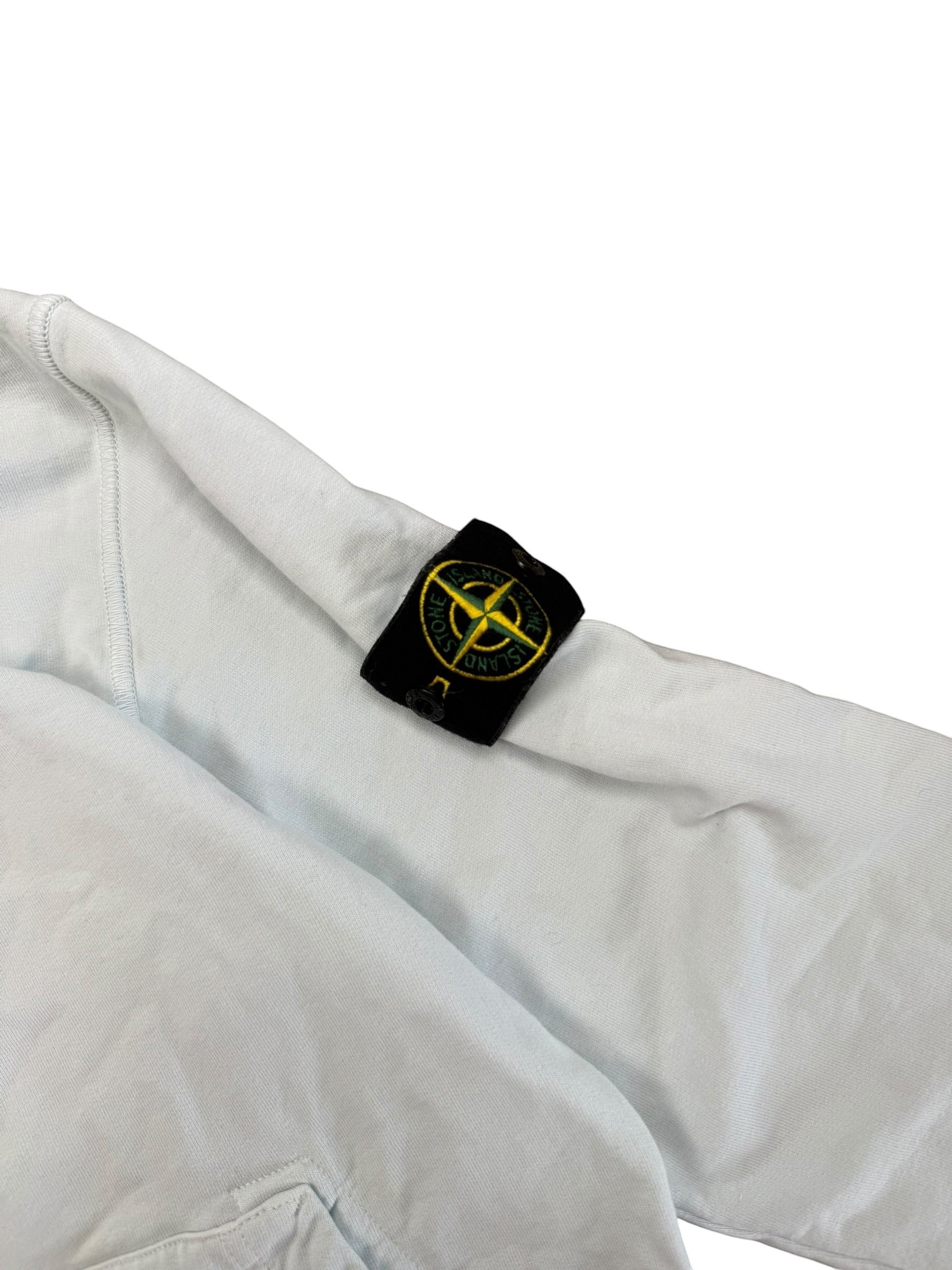 Archive No.9 light blue Stone Island pullover hoodie with signature compass badge on sleeve. Cotton material.