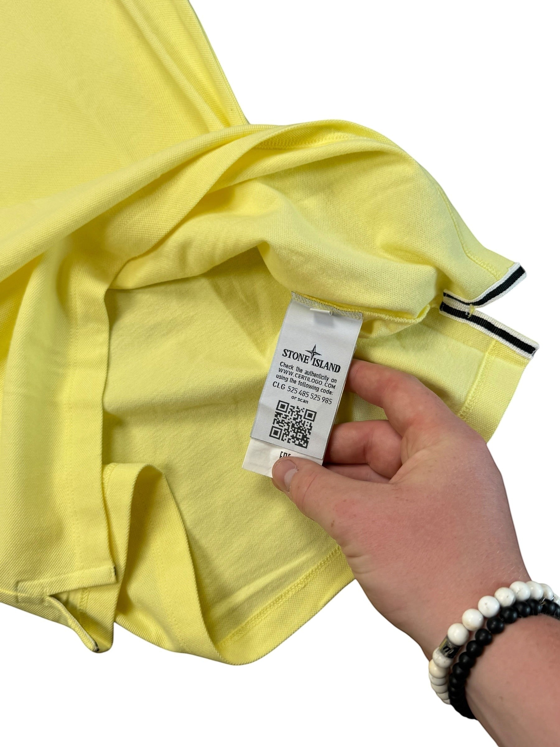 Archive No.9 Stone Island yellow cotton polo shirt showing the interior Certilogo authenticity tag and QR code.