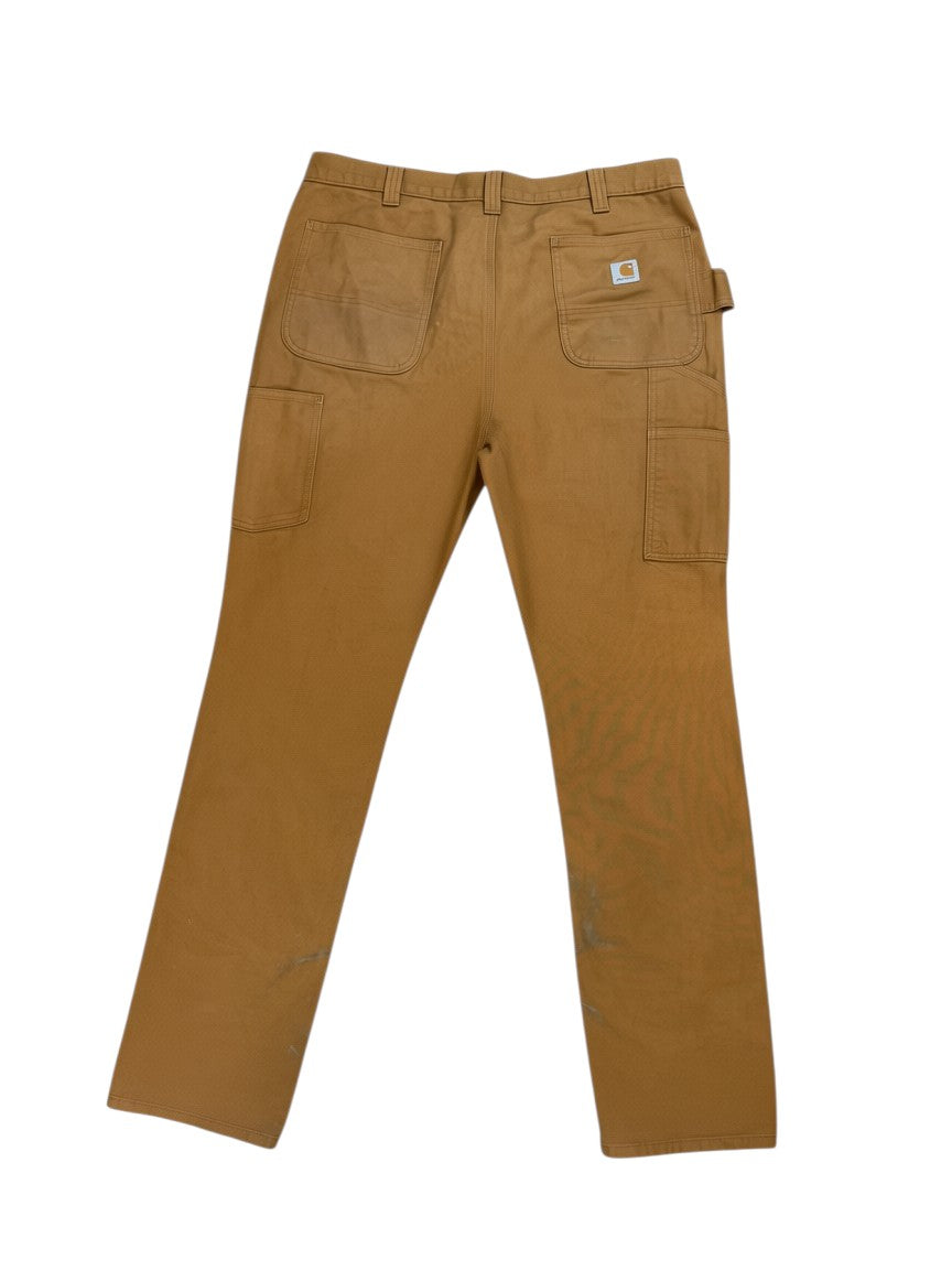 Archive No. 9 vintage tan Carhartt double knee work trousers, 99% cotton, size W38. Features straight cut fit and utility pockets.