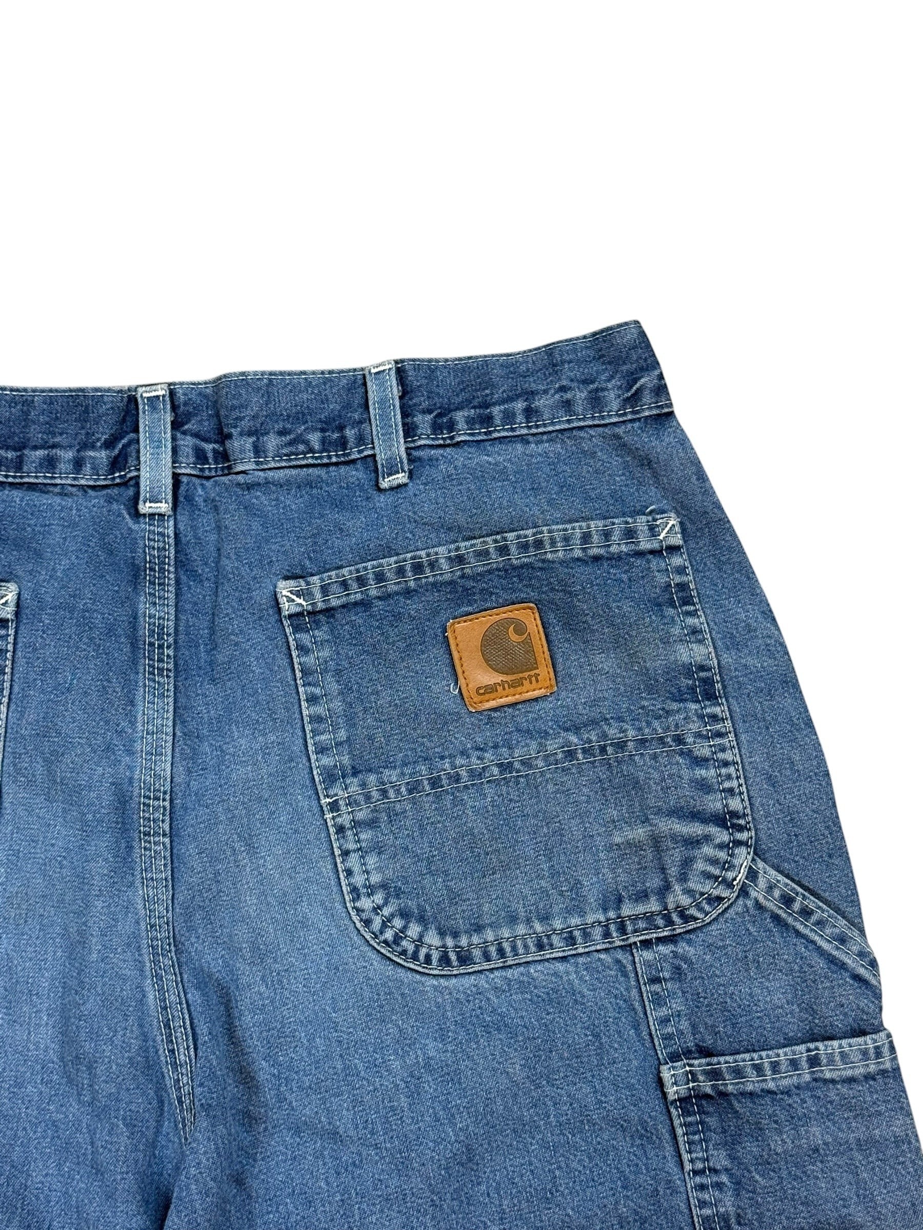 Archive No. 9 vintage navy blue denim jeans with a straight cut fit and iconic Carhartt leather patch on the back pocket. Size W36.