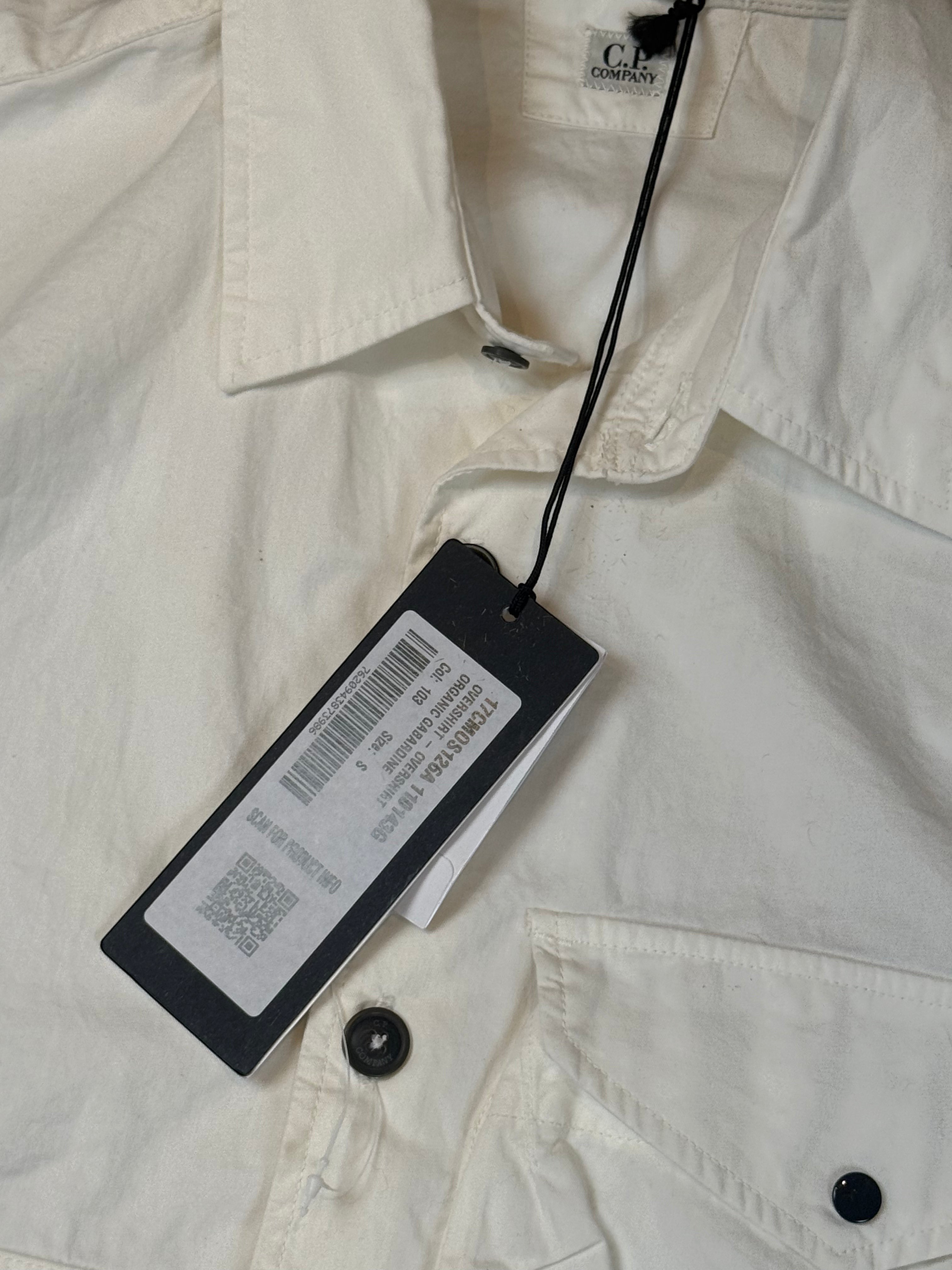 Archive No. 9 C.P. Company white organic gabardine overshirt, size S, with button closure and iconic lens detail.
