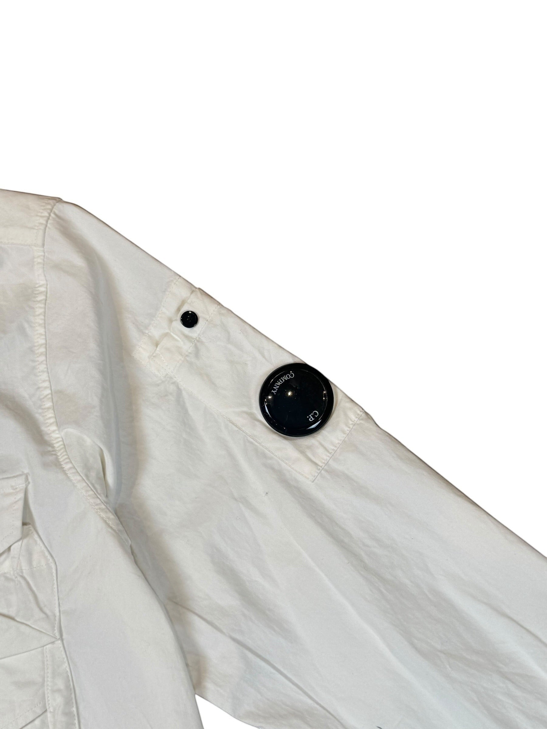 Archive No. 9 white C.P. Company lightweight button-up overshirt with iconic lens detail on the arm.