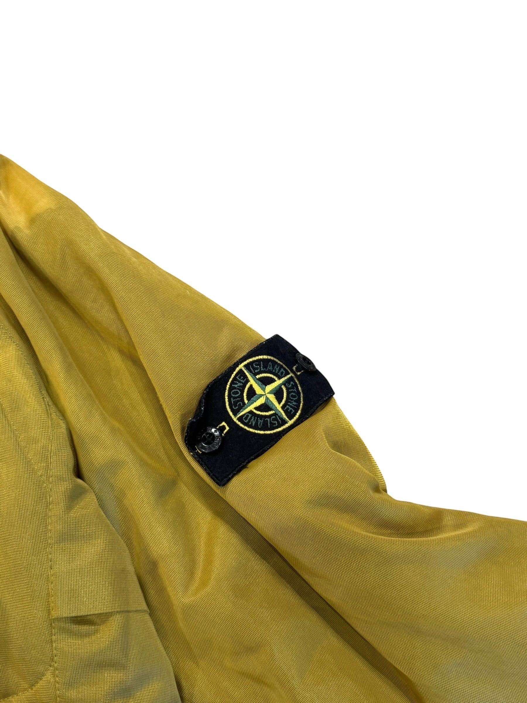 Archive No. 9 vintage yellow Stone Island down-filled jacket, size Large. Features breathable fabric and iconic badge.